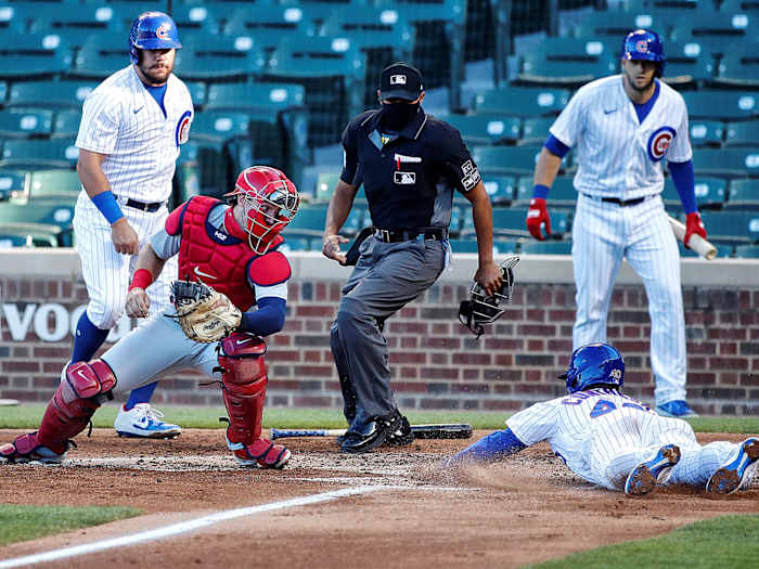 A Cubs player slides into home plate